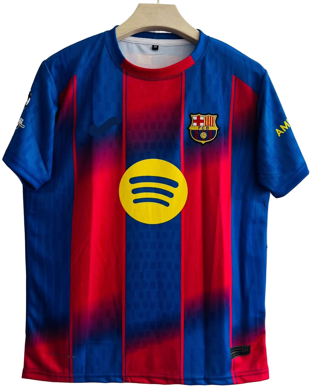 Blue and red sports jersey with a prominent yellow logo on a white background