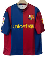 Red and blue sports jersey with Nike and UNICEF logos on a hanger