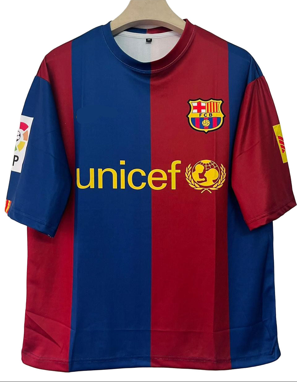 Red and blue sports jersey with Nike and UNICEF logos on a hanger