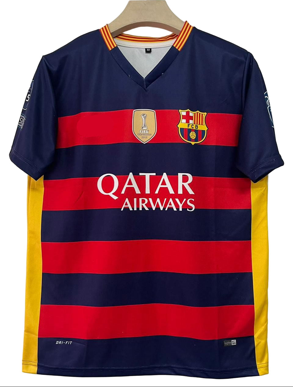 Barcelona football jersey with Nike logo and Qatar Airways branding on a hanger.